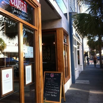 A physical Closed for Business sign hanging in a window