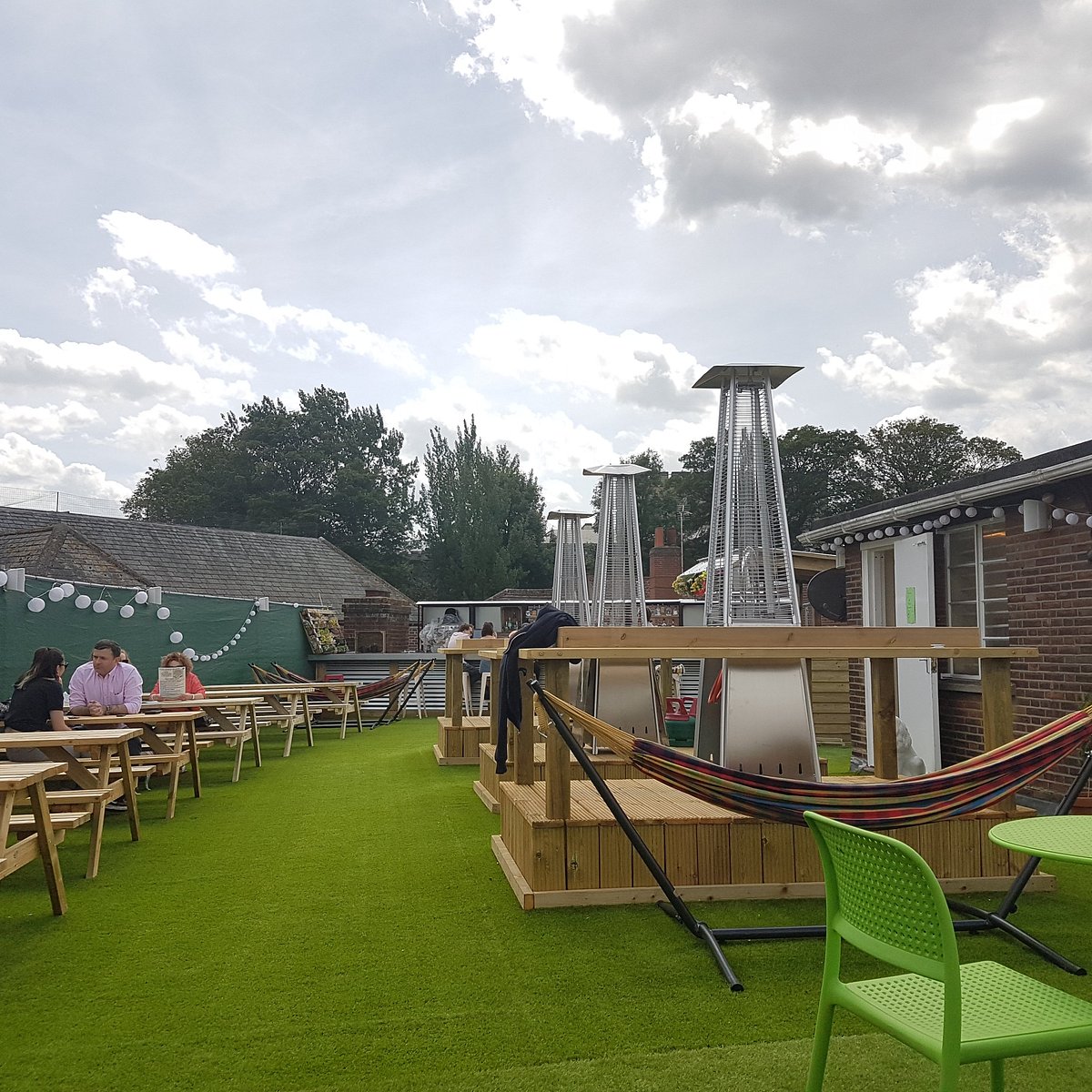 View of the rooftop terrace seating area at Gonzo's Norwich featuring eclectic decor and outdoor tables