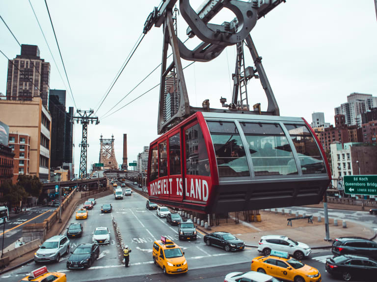Interior view of the Roosevelt Island Tram cabin looking out over the East River