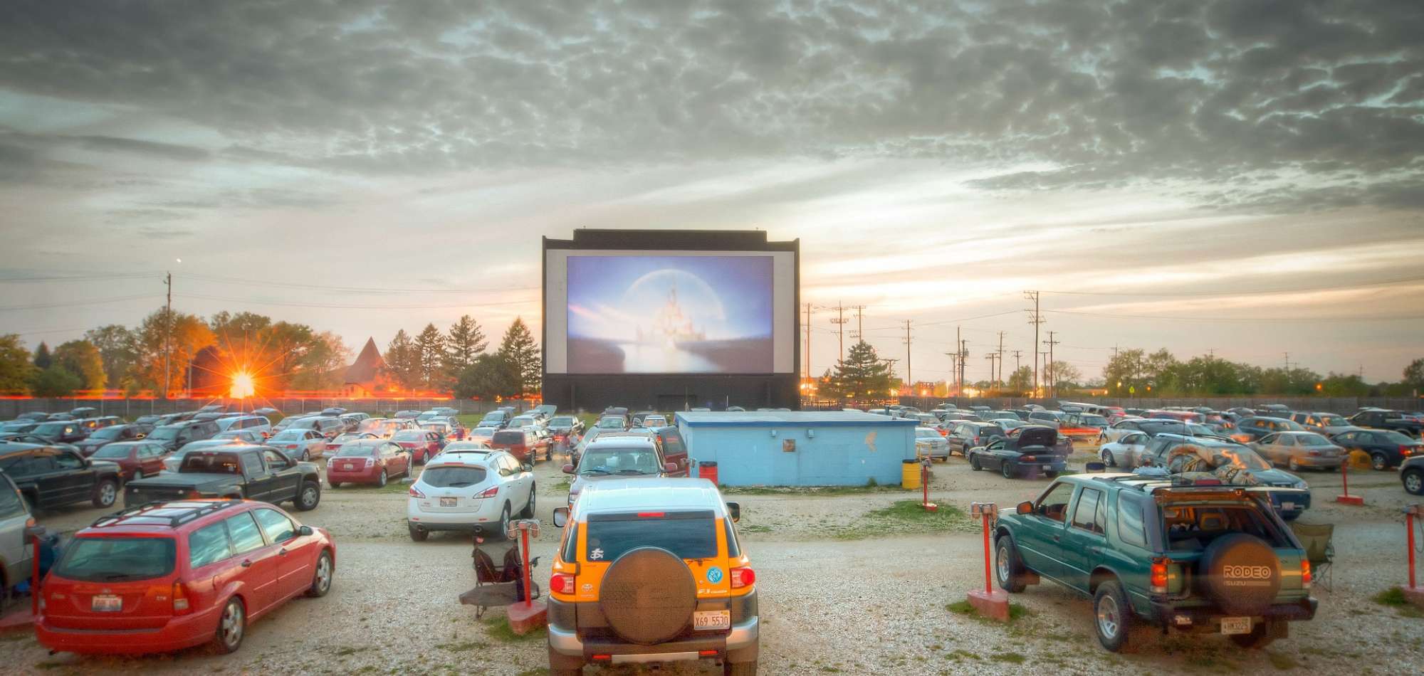 The iconic neon sign of the McHenry Drive-In Outdoor Theatre glowing at night