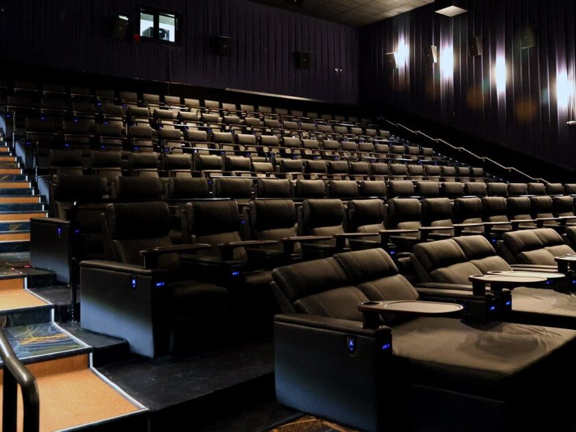 Modern luxury cinema recliners showing fixed center consoles with cup holders
