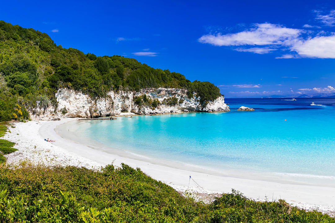 A scenic view of a popular summer vacation destination with turquoise water and coastal architecture