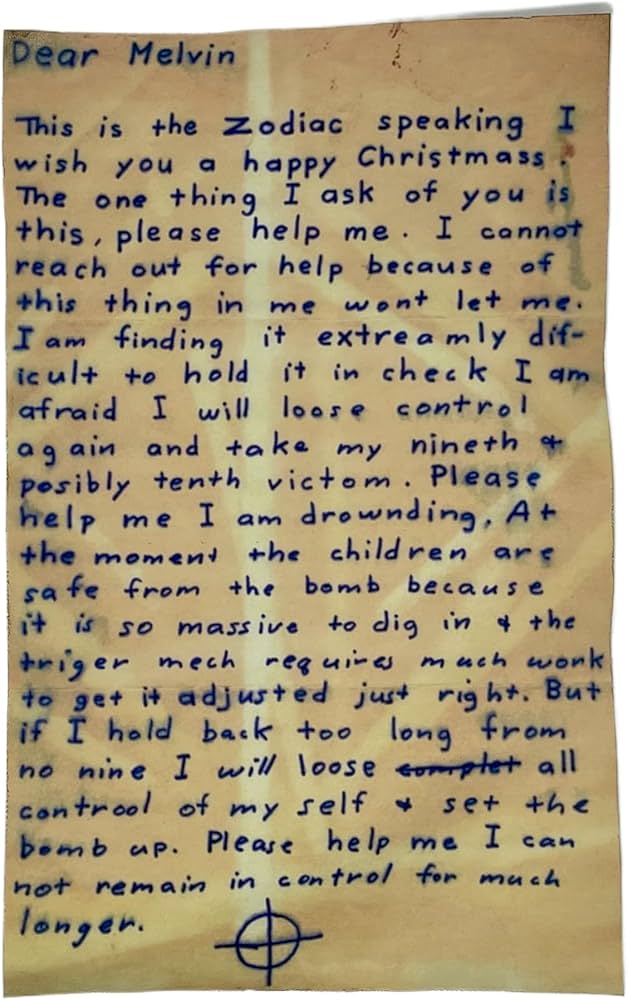 A reproduction of a Zodiac Killer letter showing the distinct handwriting and crosshair symbol
