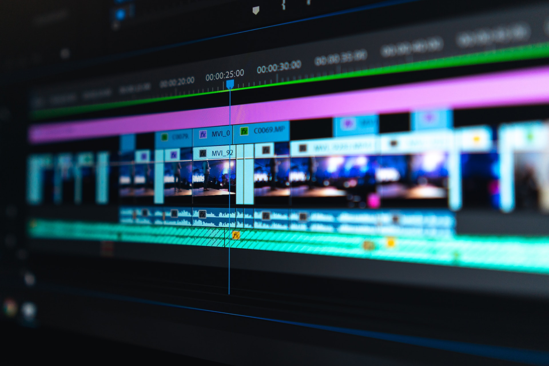 A professional video editor working on a dual monitor setup with a complex timeline