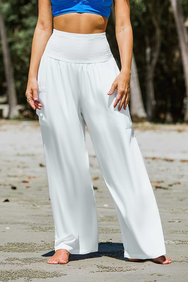 Woman wearing white smocked waist wide leg pants with a relaxed top