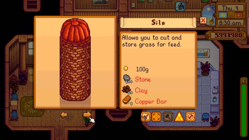 A completed silo standing on a Stardew Valley farm next to a barn